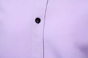 Close-up detail of a light purple men's shirt showing fabric texture and a black button.