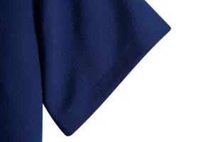 Close-up detail showing the high-quality fabric texture and sleeve stitching of a navy shirt