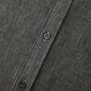 Macro view showing the grey cotton linen fabric texture and button detail of shirt