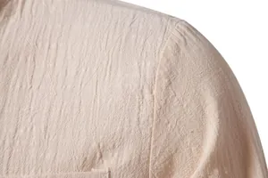 Close-up detail of the breathable cotton linen fabric texture on a men's shirt shoulder