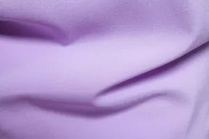 Macro detail of soft purple cotton blend fabric showing fine textile weave texture