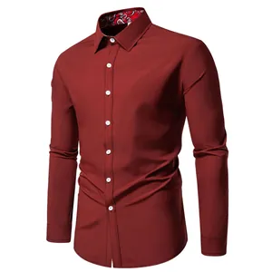 Detail of men's burgundy long-sleeved shirt with paisley patterned inner collar