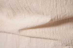 Macro close-up view of breathable cotton linen fabric texture on men's solid color shirt