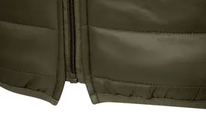 Detailed macro view of olive green quilted winter jacket showing zipper and hem finish