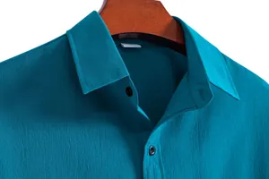 Close-up detail of a teal men's casual lapel shirt showing textured fabric and collar.
