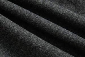 Detalle macro de la gruesa textura de lana gris carbón del abrigo de lana para hombre.