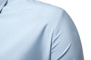 Close-up of light blue fabric texture on a men's casual long sleeve dress shirt