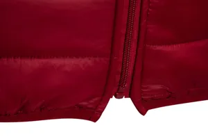 Close-up detail of smooth red puffer jacket zipper and reinforced hem stitching finish