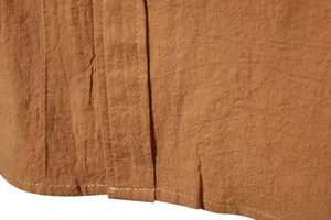 Detail view of men's cotton linen long-sleeve shirt showing fabric texture and stitching.