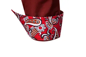 Macro detail of men's casual shirt cuff featuring vibrant red paisley floral pattern lining