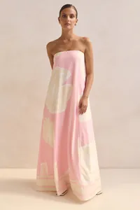 Full view of elegant strapless pink maxi dress with large floral print on model