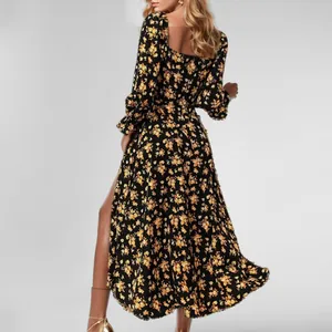 Back view of a French floral print midi dress with long sleeves and a thigh-high slit.