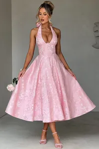 Full-length view of an elegant pink floral jacquard halter neck evening gown for women