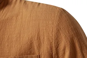 Close-up of brown linen-cotton fabric texture on men's shirt shoulder.