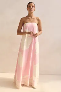 Elegant strapless pink maxi dress with large floral print, perfect for summer vacations.