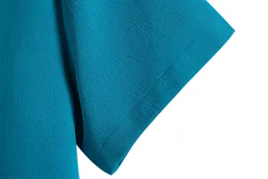 Detailed view of the cuff stitching and textured fabric on a men's casual shirt.