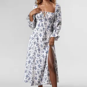 Close-up detail of white floral midi dress featuring a square neck and high thigh slit.