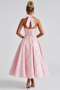 Elegant pink jacquard halter-neck evening dress detailed back view with large bow and lace-up