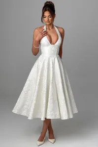 Detail of white V-neck halter jacquard dress with elegant A-line silhouette and midi length