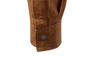 Close-up detail of a brown cotton linen shirt cuff with a single button closure