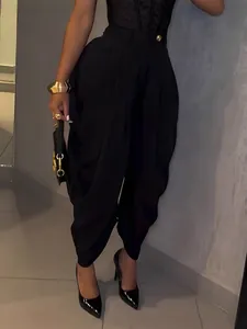 High-waisted black tulip pants for women featuring a pleated front and elegant drape detail