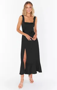 Detail view of an elegant black slit dress with a waist tie and square neck style