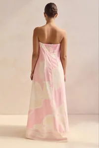 Elegant rear view of a strapless pink maxi dress featuring large cream floral patterns