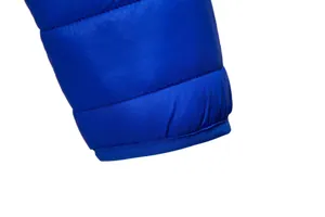 Macro detail of high-quality stitching and blue fabric on men's winter puffer jacket sleeve