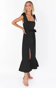 Full length view of an elegant black midi dress with shoulder ties and front slit