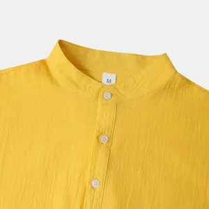 Detail macro view of men's yellow cotton linen stand-up collar shirt with size M label