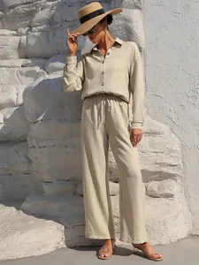 Elegant beige two-piece linen-look lounge set featuring a button-down shirt and wide-leg trousers