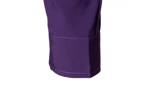 Detailed view of a purple men's long-sleeve shirt cuff showing quality stitching texture