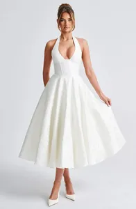 Elegant white jacquard halter midi dress with deep V-neck and flared skirt detail.