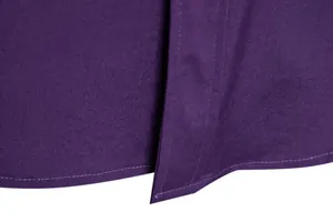 Close-up macro shot of fine stitching on the purple men's solid color casual shirt hem.