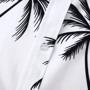 Gros plan d'une chemise hawaïenne blanche avec imprimé palmier noir et bouton transparent