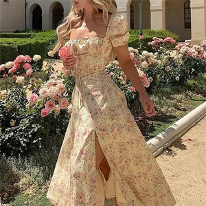 French floral print midi dress with puff sleeves and side slit in garden setting