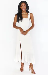 Elegant white square-neck midi dress with side slit and ruffle hem details