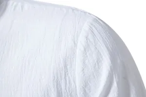 Macro view of white cotton linen shirt showing shoulder seam and fabric texture details