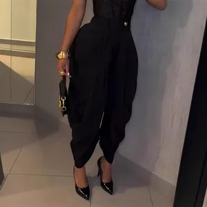 High-waist black lantern trousers with draped design for an urban chic look.