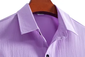 Detailed view of purple crinkle fabric and lapel collar on a casual men's short-sleeve shirt