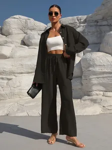 Detailed view of women's black two-piece casual set with shirt and wide-leg pants