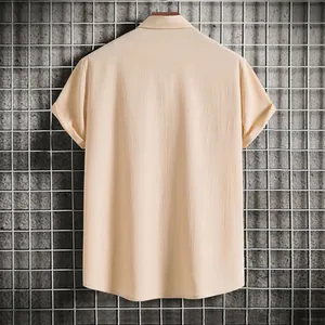 Back view of a men's beige short sleeve shirt featuring a textured crepe fabric finish