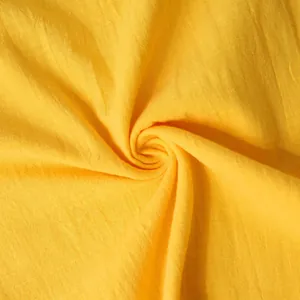 Close-up detail showing the breathable texture of yellow cotton-linen casual shirt fabric