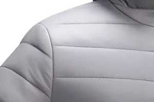 Detailed high-quality close-up of precision stitching on men's lightweight grey puffer jacket