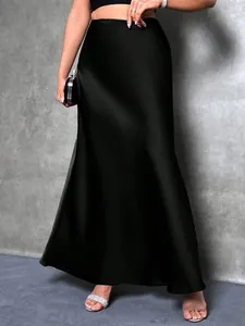 Close-up view of an elegant black satin maxi skirt featuring a smooth silk-like texture