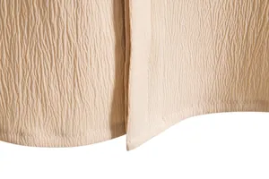 Macro detail of men's summer beige short sleeve shirt hem showing textured fabric