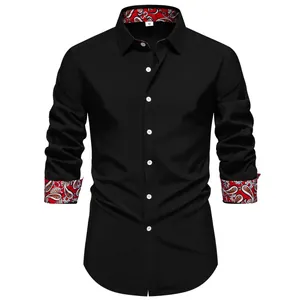 Close-up of black men's long-sleeve shirt with red paisley print on collar and cuffs
