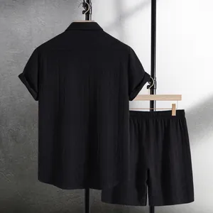 Close-up of black men's short sleeve shirt and shorts set with ethnic waffle texture