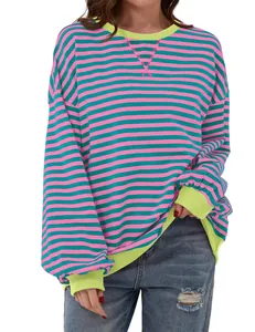 Detailed macro view of pink and green horizontal striped sweatshirt with neon yellow ribbed trims