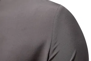Detailed macro view of dark grey fabric texture and shoulder seam on men's shirt